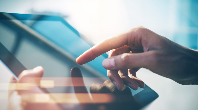 Close up shot of someone using a tablet