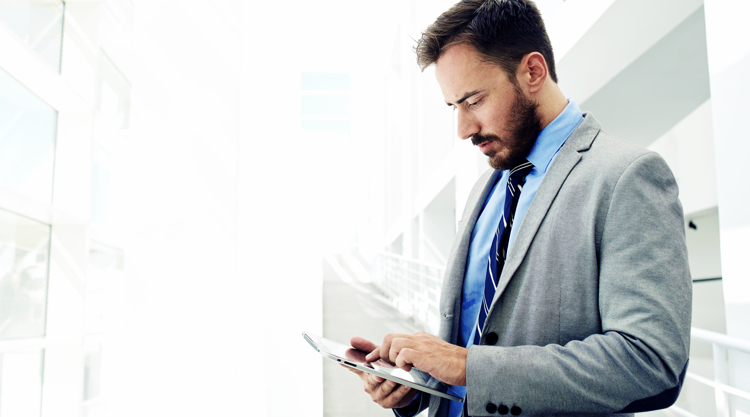 Business man looking at tablet working.