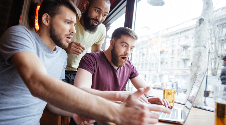 group of men at the bar watching sports