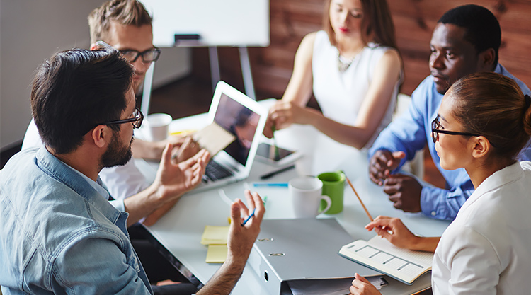 A group of co-workers sitting around a conference table