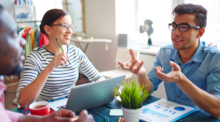 A group of coworkers seated at a table working together