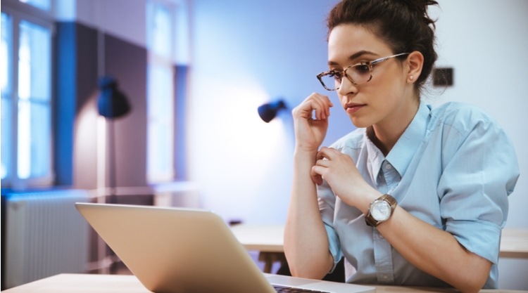 A woman working on her laptop in an office