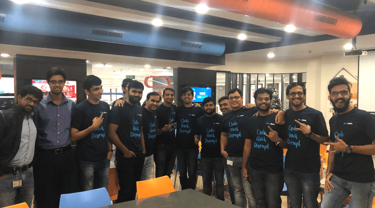 A group of men smiling in an office