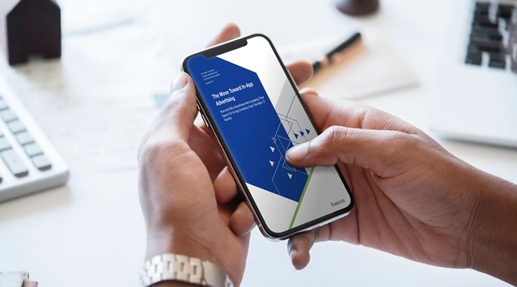 A man holding a cell phone in an office