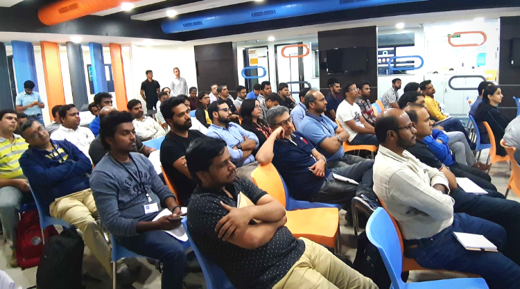 An audience of people sitting and listening to the speaker