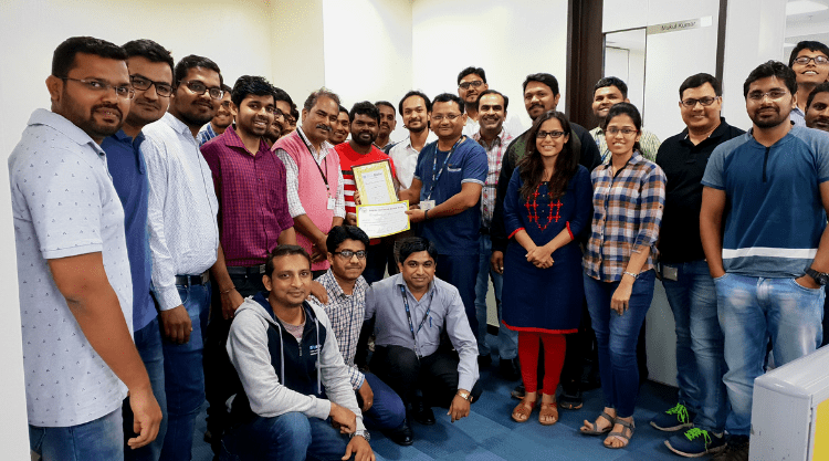 A crowd of PubMatic employees holding up an award