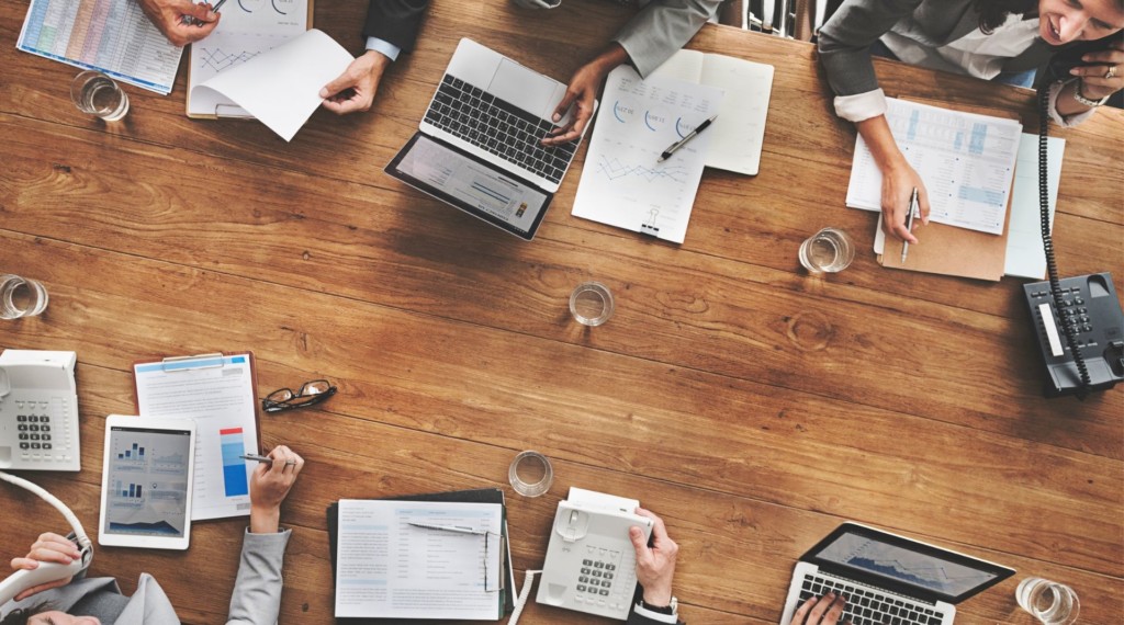 A photo of a group of people working in a conference