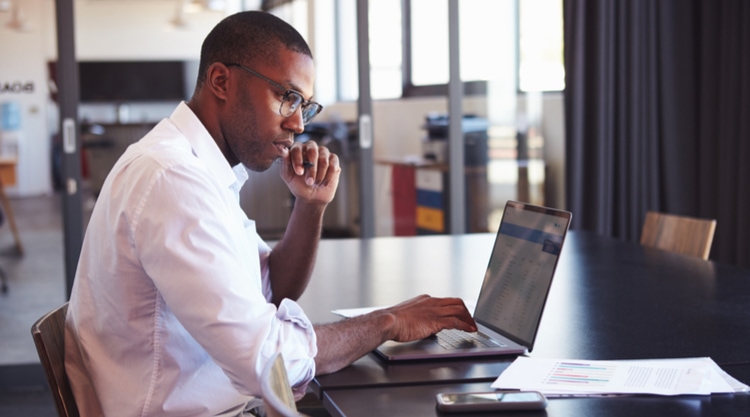 A man working on his laptop in an office