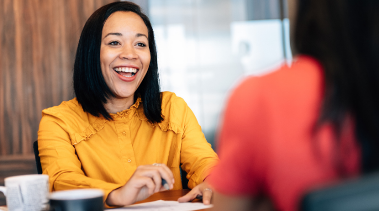 A smiling woman speaking in an office