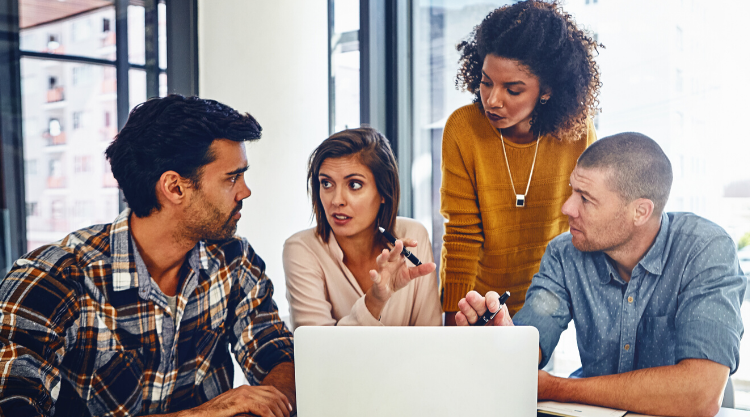 Four people working as a team in an office