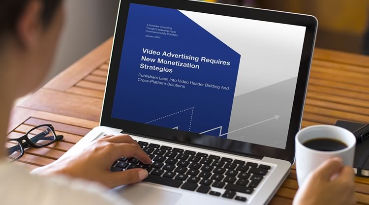 A woman is working on her laptop while holding a coffee mug. The text on the laptop screen states 