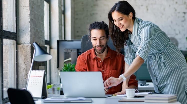 Young Businessman and Businesswoman Working Together at the Office