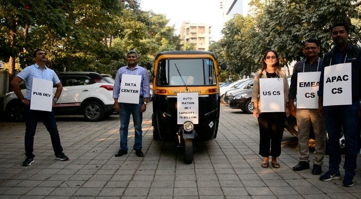 Five people stand outside with signs on their chest. The text states, 