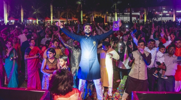 A man standing in front of a crowd of people with his arms wide open