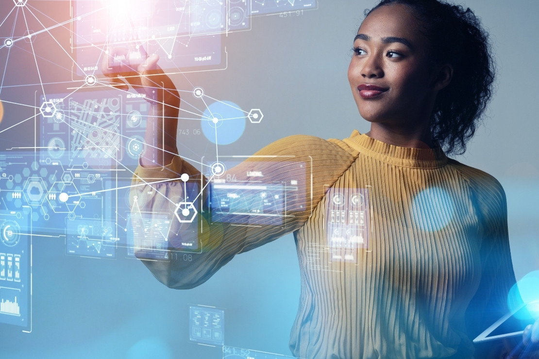 Smiling adult woman touching a holographic presentation of data and charts