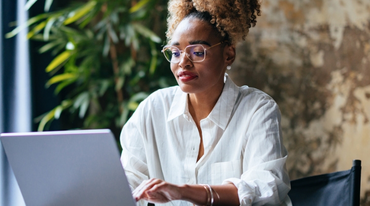 Young woman is working on a laptop computer.