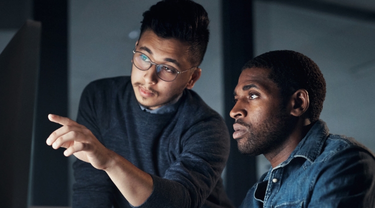 Two Young Men collaborate on a laptop