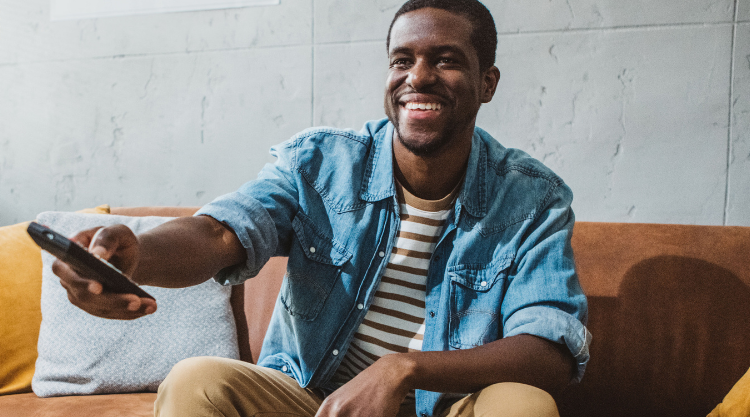 A smiling man watched television