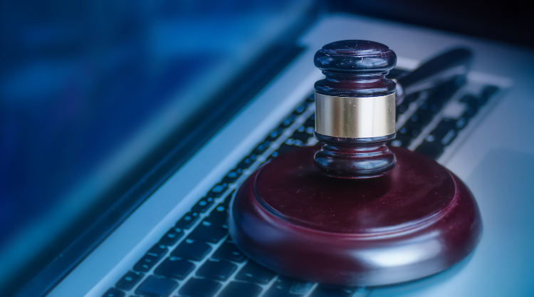 An image of a gavel on top of a laptop keyboard