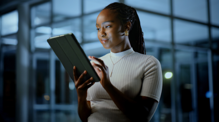 Tablet, office and black woman in business at night to research or review design for ads. Technology, online and creative brand consultant with campaign feedback or development on overtime in startup